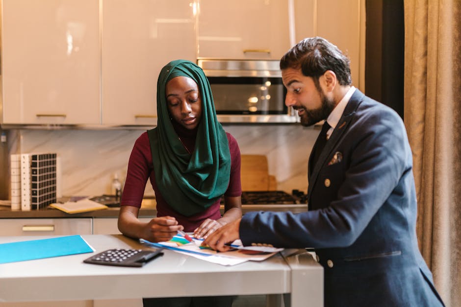 Diverse colleagues in a professional business meeting discussing documents at a modern indoor office setting.